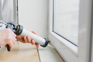 caulking windows to extend window life North Shore Home Works services Chicago, Northbrook, Highland Park, Lake Forest, Lake Bluff, Glenview, Kenilworth, Wilmette, Winnetka, and surrounding IL areas